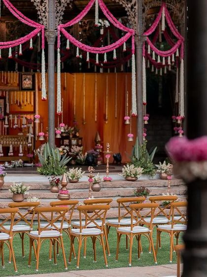 The stage is set for a naming ceremony at the Colonial Bandstand, with traditional decor and seating for guests.