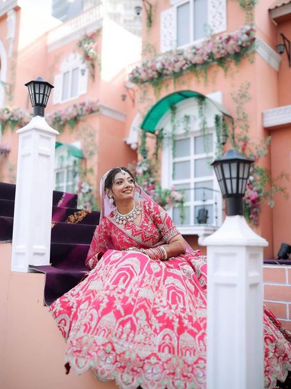This bride's look was straight out of a traditional storybook. Her vibrant pink lehenga is paired with elegant makeup that is both beautiful and timeless.