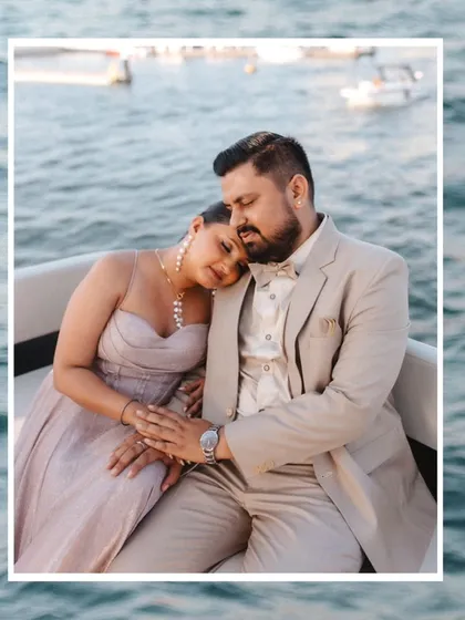 A quiet moment of peace and affection on the water. This beautifully framed shot captures the couple's serene connection amidst the gentle waves.
