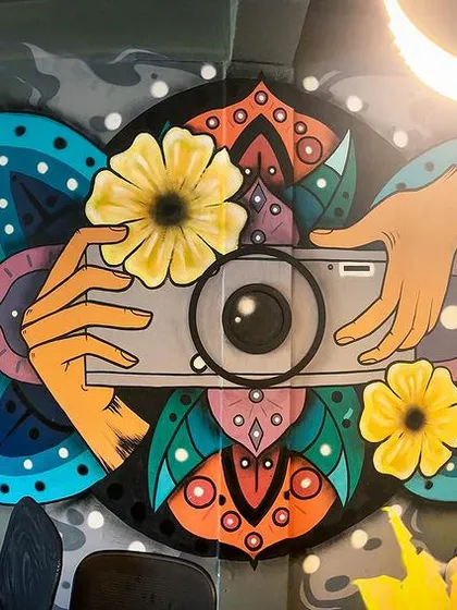 For this photography studio in South Delhi, I created a custom mural blending a camera with intricate mandala and floral designs. This piece is a great example of how I translate a brand's creative identity into a unique visual story.
