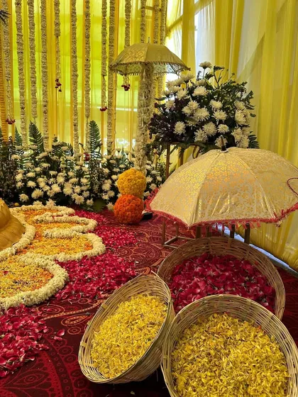 Baskets filled with red and yellow flower petals, ready for a joyous celebration. The decorative umbrellas add a touch of traditional charm.