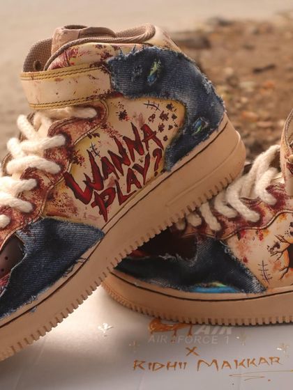 "Wanna Play?" I painted this iconic Chucky quote on the side of the sneakers, using a bloody, dripping font to complete the terrifyingly cool design.