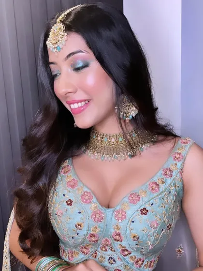 A close-up of the colorful eye makeup. The blend of neutral tones with a pop of green is a unique and stunning combination.