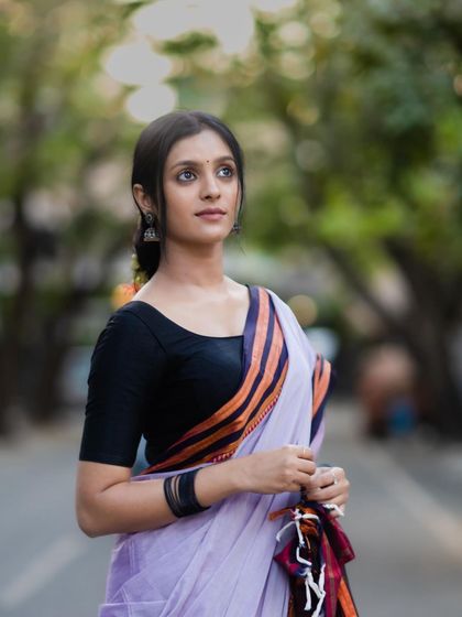 A portrait that highlights the model's serene expression, perfectly matching the timeless vibe of the Ilkal saree.