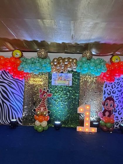 A slightly different view of Hitanshu's jungle party, showcasing the colorful balloon clusters and the playful animal characters that made the celebration so special.