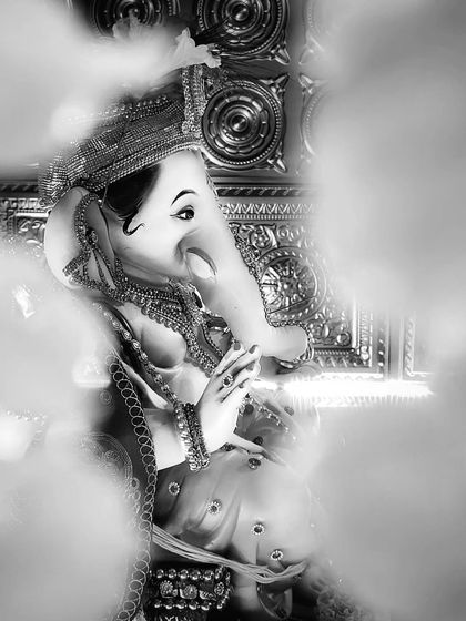 A timeless black and white portrait of Lord Ganesha. The desaturated effect, combined with a soft, smoky foreground, gives this image a classic and ethereal quality.