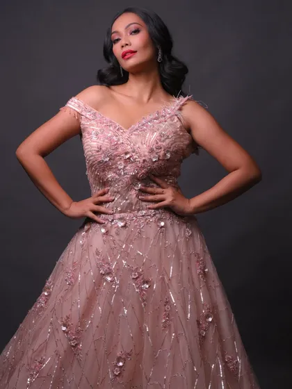 A full-length shot showcasing the beautiful pink gown and how the makeup complements it.