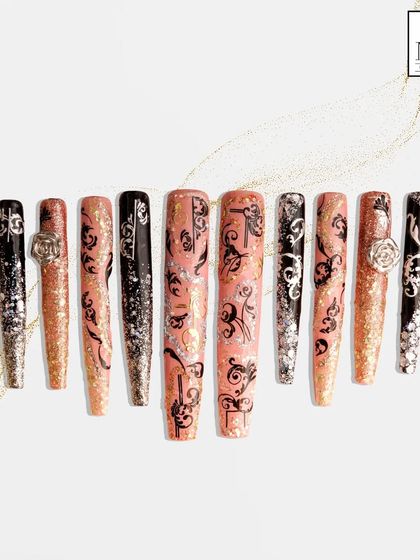 For this design, I blended a soft pink glitter base with bold, black filigree patterns and 3D rose embellishments. It’s a dramatic and romantic look that combines delicate details with a strong, graphic element.