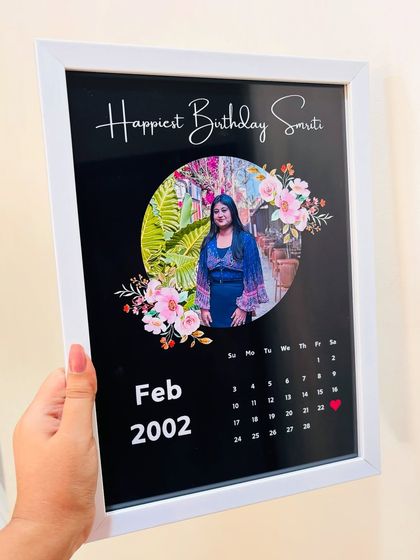 Holding my popular calendar frame, which features a photo, name, and a calendar of the birth month with the special day marked.