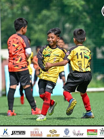 The joy of competing. A player smiles mid-game, showing the love for football that we aim to foster in all our athletes.