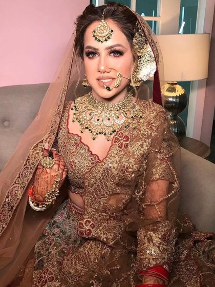 A side profile of the bride, showing the intricate details of her passa and the heavy embroidery on her lehenga.