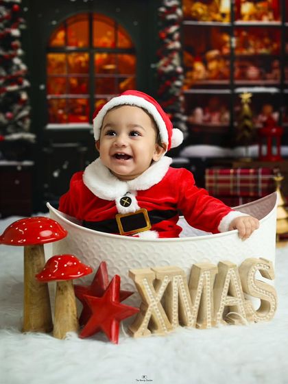 The magic of Christmas. This baby boy, dressed as Santa, has the biggest smile in our festive holiday-themed studio session.
