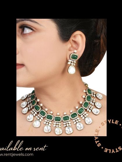 For a unique and stylish look, consider this oxidized white silver Kundan Polki necklace. The contrast of the silver with the green stones makes it a modern and eye-catching choice.