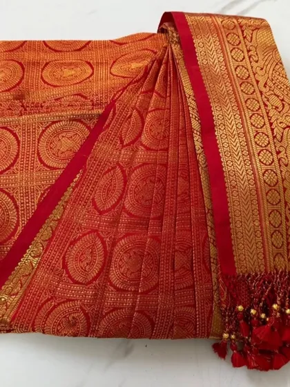 This is where the magic begins. A stunning red and gold bridal Kanjeevaram, with its skirt and pallu pleats crisply pressed and folded. It's boxed and ready for the bride to wear without any last-minute stress.