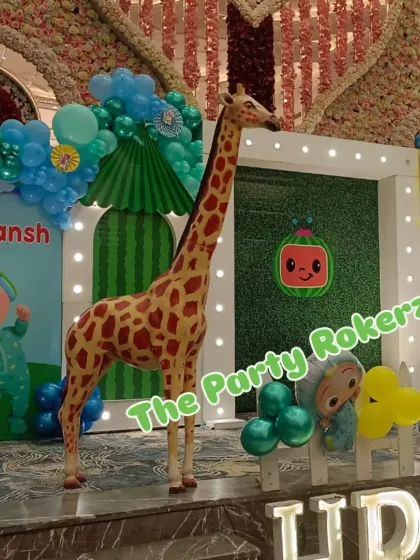 For this large-scale Cocomelon party, I included a life-sized giraffe prop to add a 'wow' factor. The decor also features a custom backdrop and character cutouts.