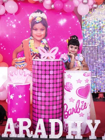 A charming 'Woodland' themed birthday party, with rustic decor, forest animal cutouts, and natural elements, creating a cozy and enchanting setting.