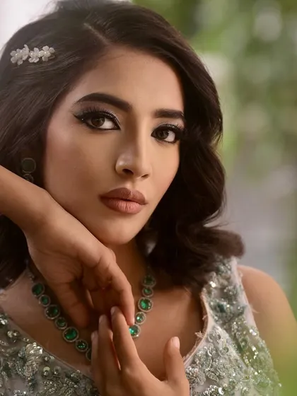 This pose highlights the sharp, clean winged eyeliner, a fundamental skill that we perfect in the course.