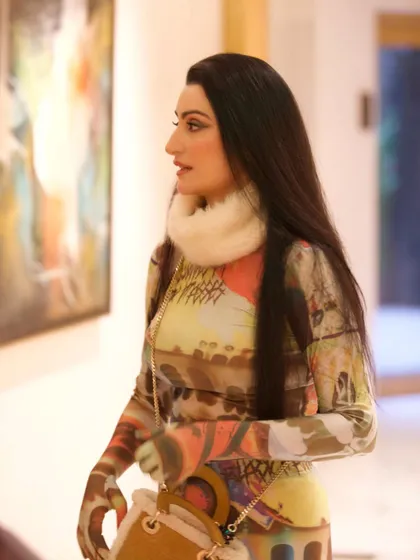 A profile view of the custom Huemn outfit. The faux fur collar adds texture and a wintery feel, contrasting with the artistic print of the catsuit.