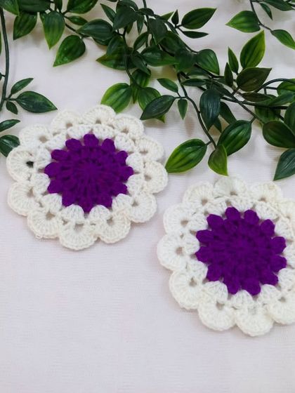 A simple yet elegant doily in purple and white. These smaller pieces are perfect as coasters or to place under small decorative items.