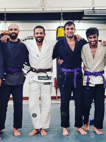 Another shot of our newly promoted purple belts with the coaching staff.