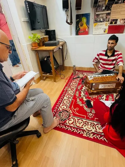 We welcome parents to observe our classes. Here, a parent sits in on a Hindustani vocal session, gaining a better understanding of the learning process and how to support the student's practice at home.