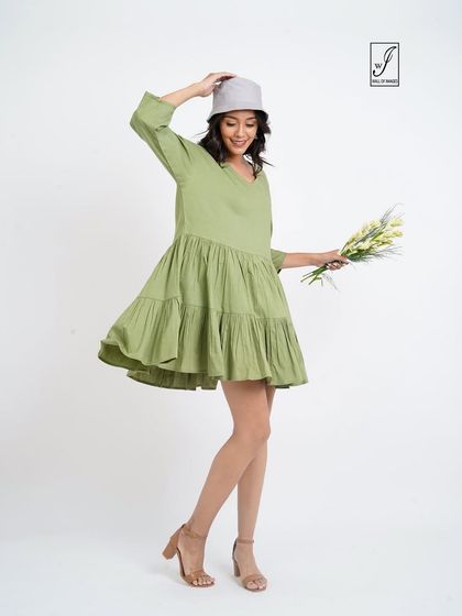 A joyful, twirling pose that captures the light and airy feel of the dress.