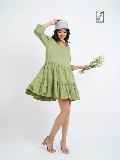 A joyful, twirling pose that captures the light and airy feel of the dress.