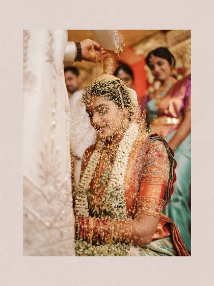 The sacred "Talambralu" ritual in a Telugu wedding, where the bride is showered with rice and pearls. This beautiful, serene moment captures Deepanjali under a shower of blessings.