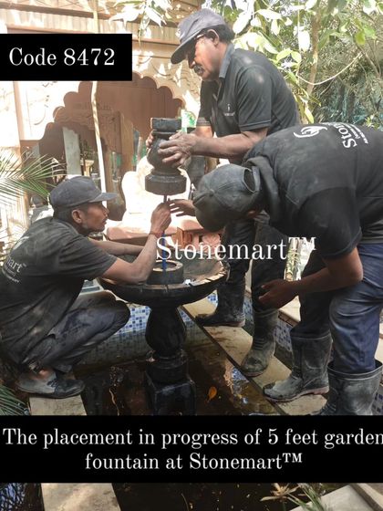 The placement of the 5-foot garden fountain requires precision and teamwork. Here, my crew carefully assembles the multi-part Grandessa fountain.