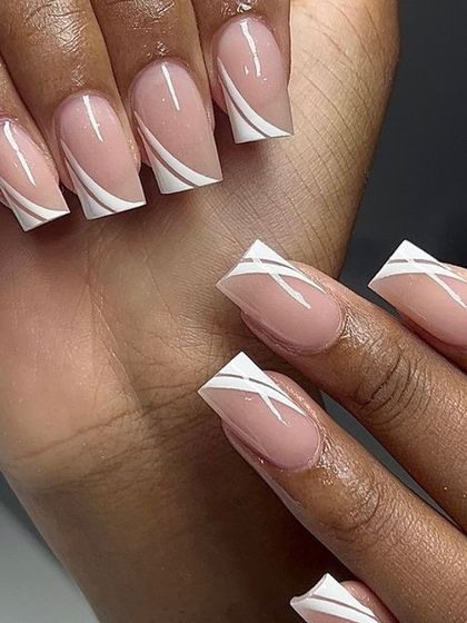 A modern, graphic design on square nails. This look features a sheer nude base with bold, intersecting white lines for a clean, architectural feel.