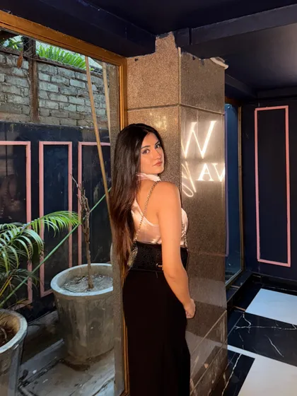A final, confident pose in my rose-gold and black outfit.