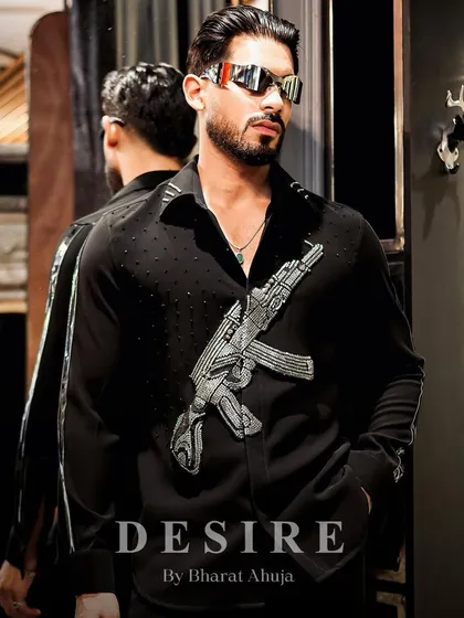 My shirts are made to make a statement, not to blend in. This piece features a powerful, hand-embroidered gun motif in striking silver beadwork, designed for the man who isn't afraid to show his rebellious side.