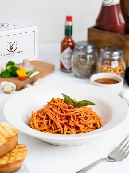 Our Spaghetti Arrabbiata offers a spicy kick. Al dente spaghetti is tossed in a fiery tomato and garlic sauce, topped with fresh basil for a classic Italian flavor.