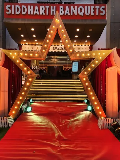 The entrance to our Bollywood-themed Sangeet, complete with a red carpet and a giant star marquee. This setup ensures every guest gets a celebrity welcome.
