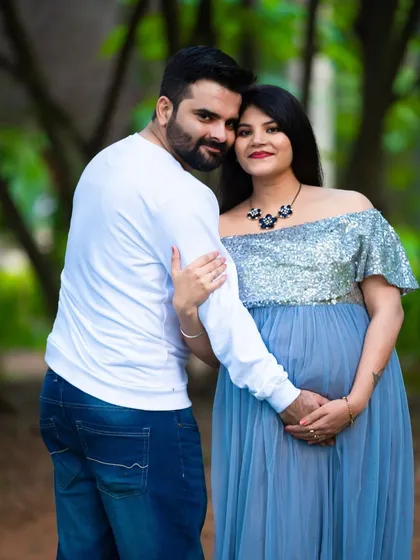 A happy and bright outdoor portrait. This couple's joy is palpable as they pose together in a beautiful park setting.