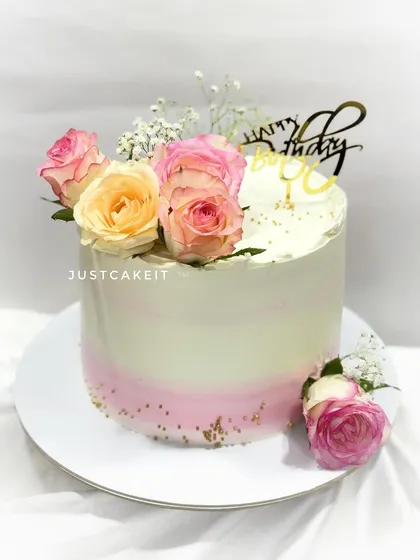 A simple and elegant cake with an ombre pink effect and fresh roses. This chocolate truffle cake travelled all the way to Dahisar to be part of a special celebration.