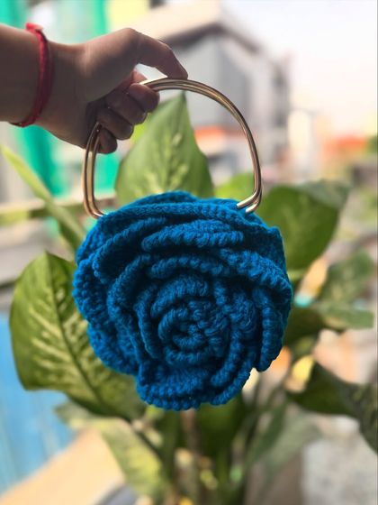 A close-up of our blue Rose bag with a metallic handle. The color is rich and the craftsmanship is impeccable.
