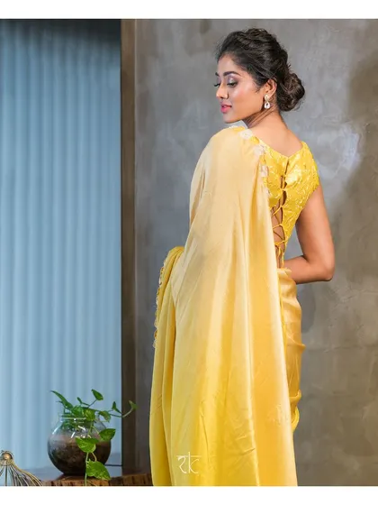 My contemporary take on the classic saree. This lime and ivory half and half creation plays with textures and tones, complemented by a unique lace-up blouse that adds a modern, alluring detail.