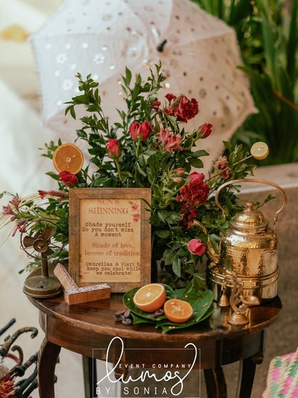 A charming sign explaining the "Sun's Shinning" station, where guests can pick up umbrellas and hand fans.