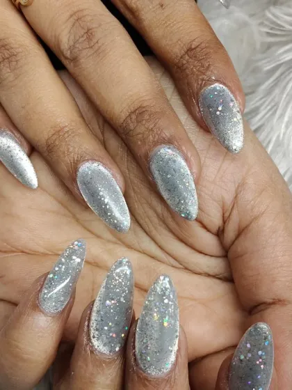 A close-up of the silver glitter nails, showing the mix of fine and holographic glitter particles that create so much sparkle.