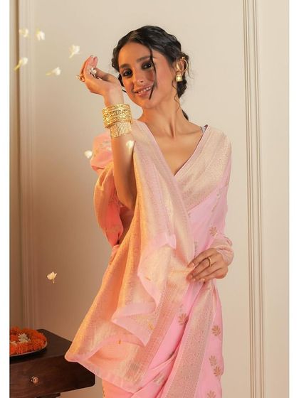 A playful, candid-style shot for Binal Patel's saree collection, with flower petals adding to the festive mood.