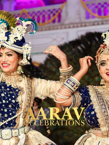 A close-up of the artists playing Radha and Krishna. Their detailed costumes, expressive faces, and joyful energy are key to bringing the authenticity of the Raasleela to life.