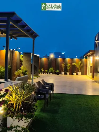 The Sushant Lok project at night, with dramatic lighting highlighting the different architectural elements and creating a luxurious ambiance.