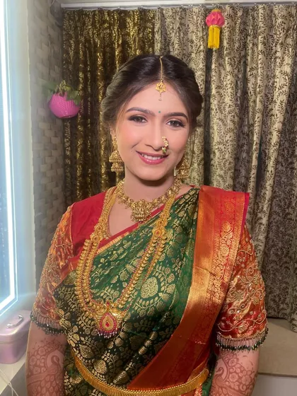 A bright, happy smile from the bride-to-be during her pre-engagement puja. The makeup is kept traditional and radiant.