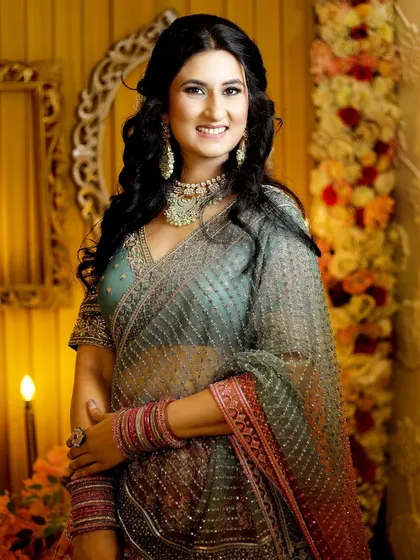 A radiant portrait of the bride-to-be in her beautiful engagement saree. Her smile lights up the entire frame.