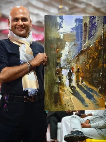 Holding my completed landscape painting after a live demonstration. This is the satisfying culmination of hours of focused work.
