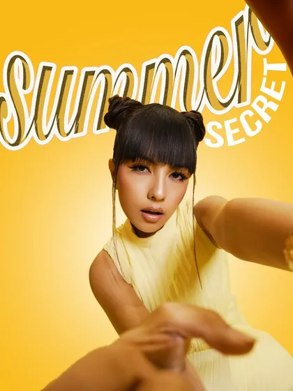 A graphic and edgy shot from the "Summer Edit" campaign. The focus is on the model's direct gaze and the bold, modern makeup, capturing a confident and fashion-forward vibe.