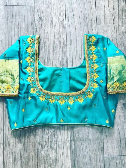 A turquoise blouse with simple yellow floral threadwork. This is a good example of my neat hand embroidery for a less formal occasion.