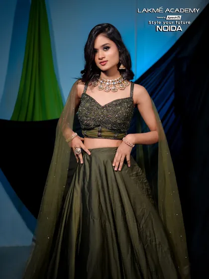 A full-length shot of a modern lehenga look. The olive green color is unique and stylish, and the makeup is done to complement it perfectly.