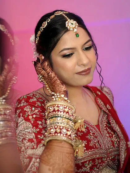 A soft, romantic profile of the bride. Her skin is glowing, and the subtle contouring defines her features beautifully.